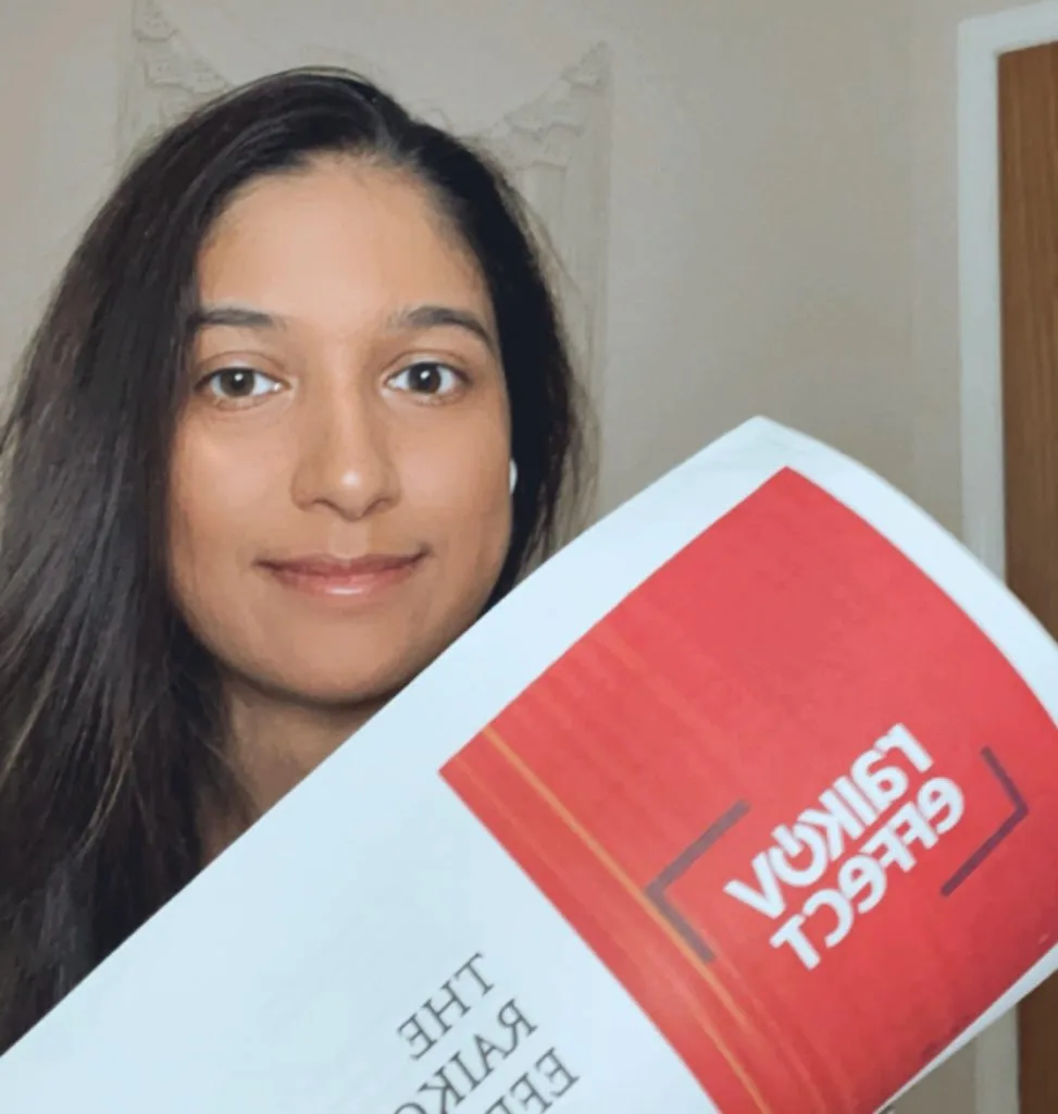 My Brutally Honest Raikov Effect Review - Does it Really work? 2 Girl holding course book for The Raikov effect review
