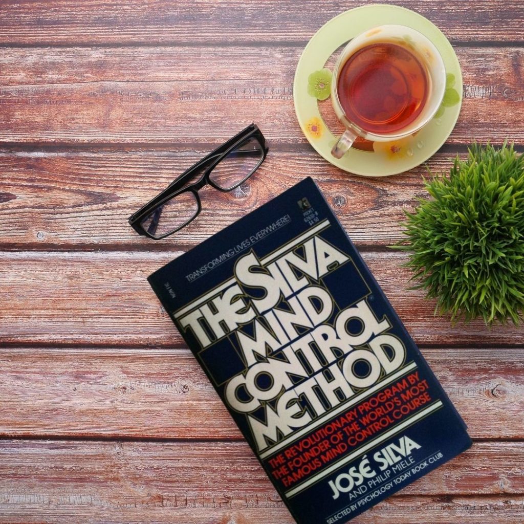 silva mind control method book by jose silva on desk with tea
